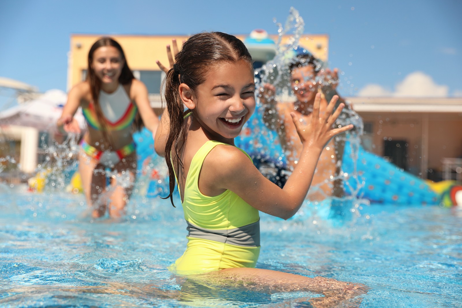 Photo of happy family having fun at water park. Summer vacation