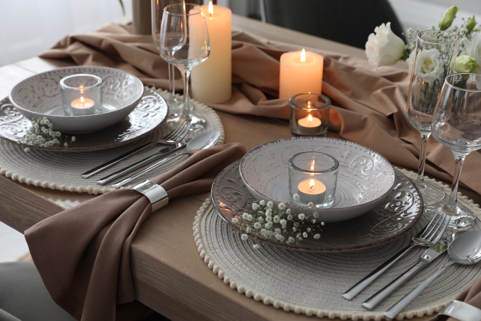 Photo of festive table setting with beautiful floral decor in restaurant