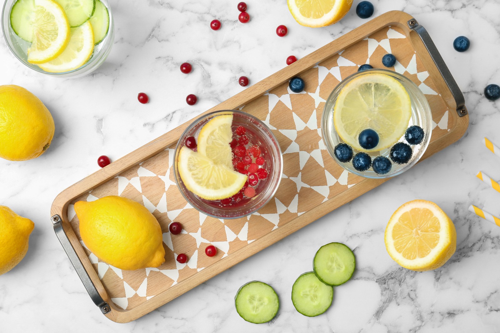 Photo of flat lay composition with delicious natural lemonade on marble background