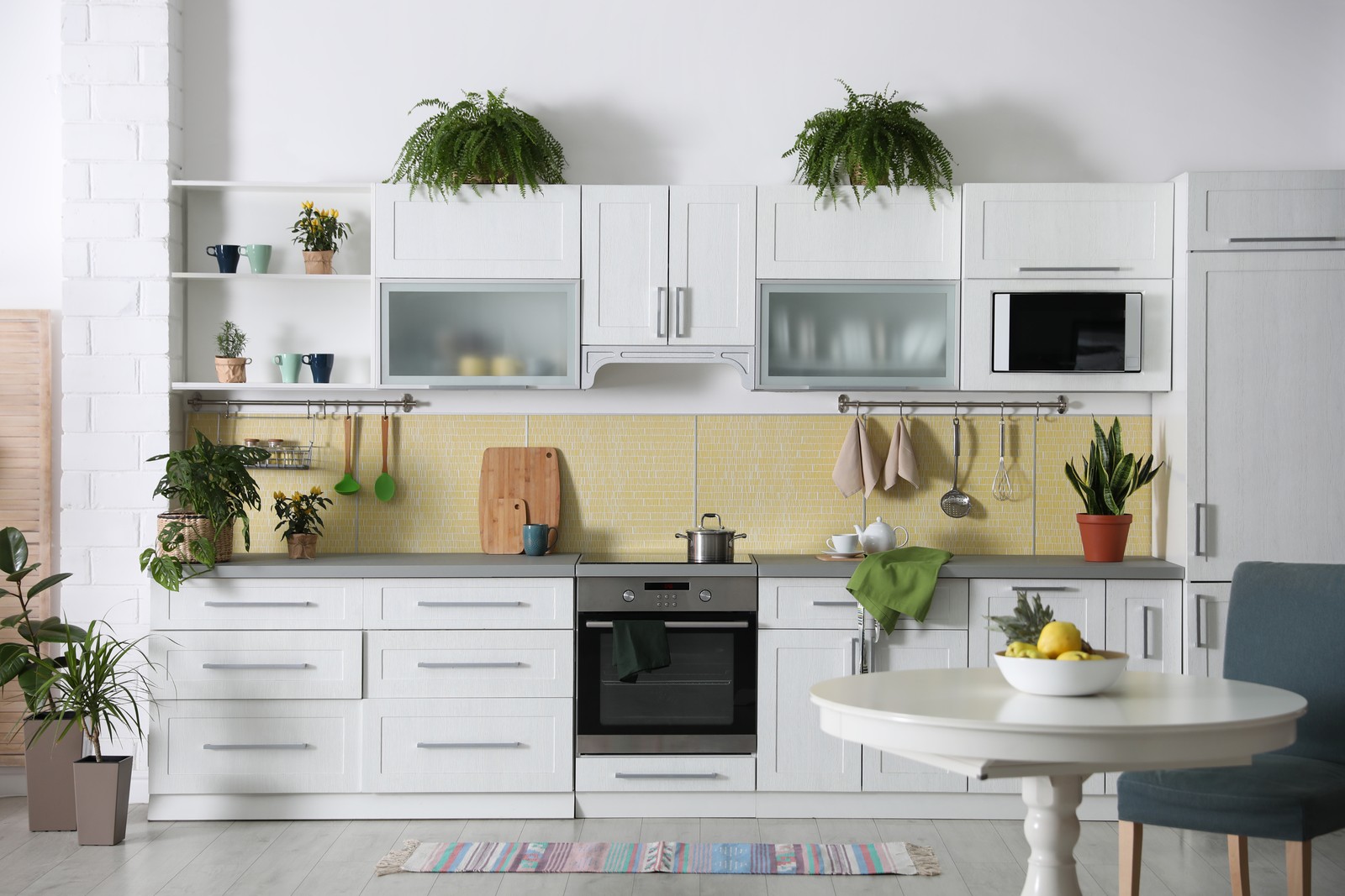 Photo of stylish kitchen interior with green plants. Home decoration