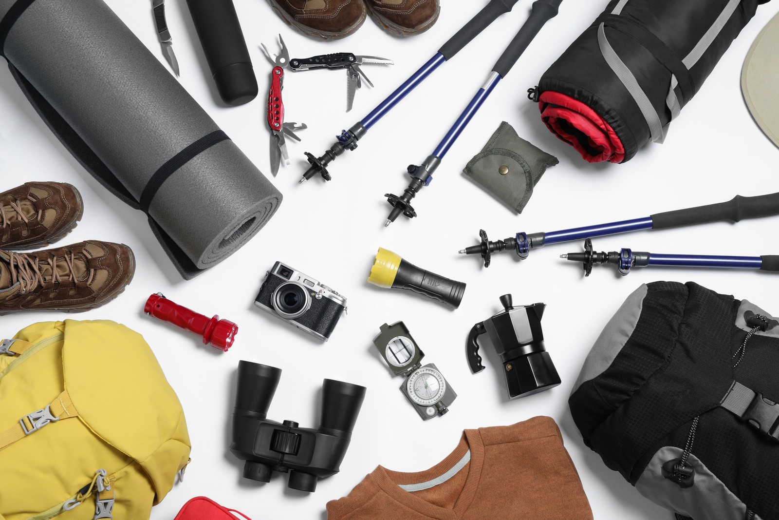 Photo of composition with backpack and other camping equipment for tourism on white background, flat lay