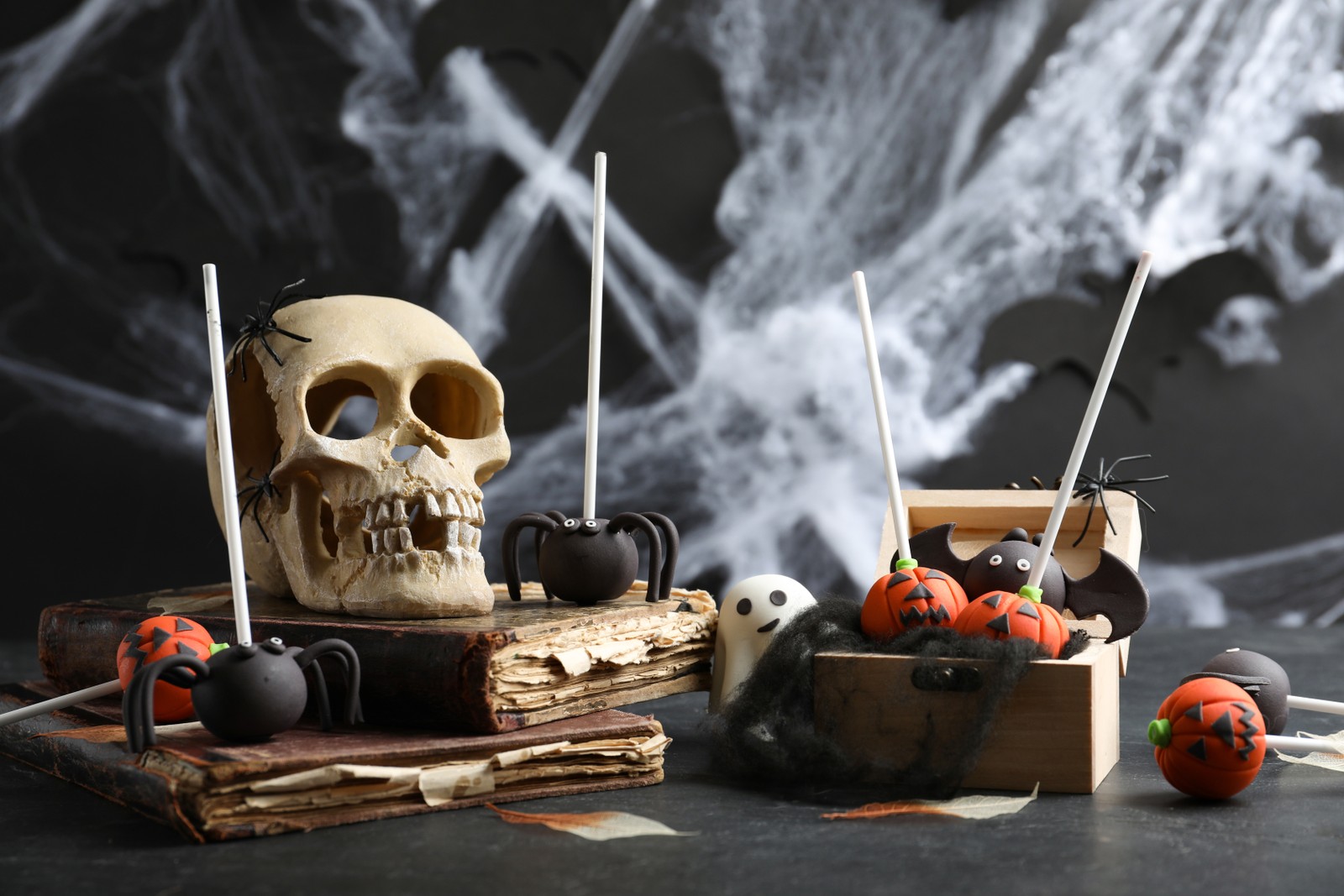Photo of different Halloween themed cake pops on black table
