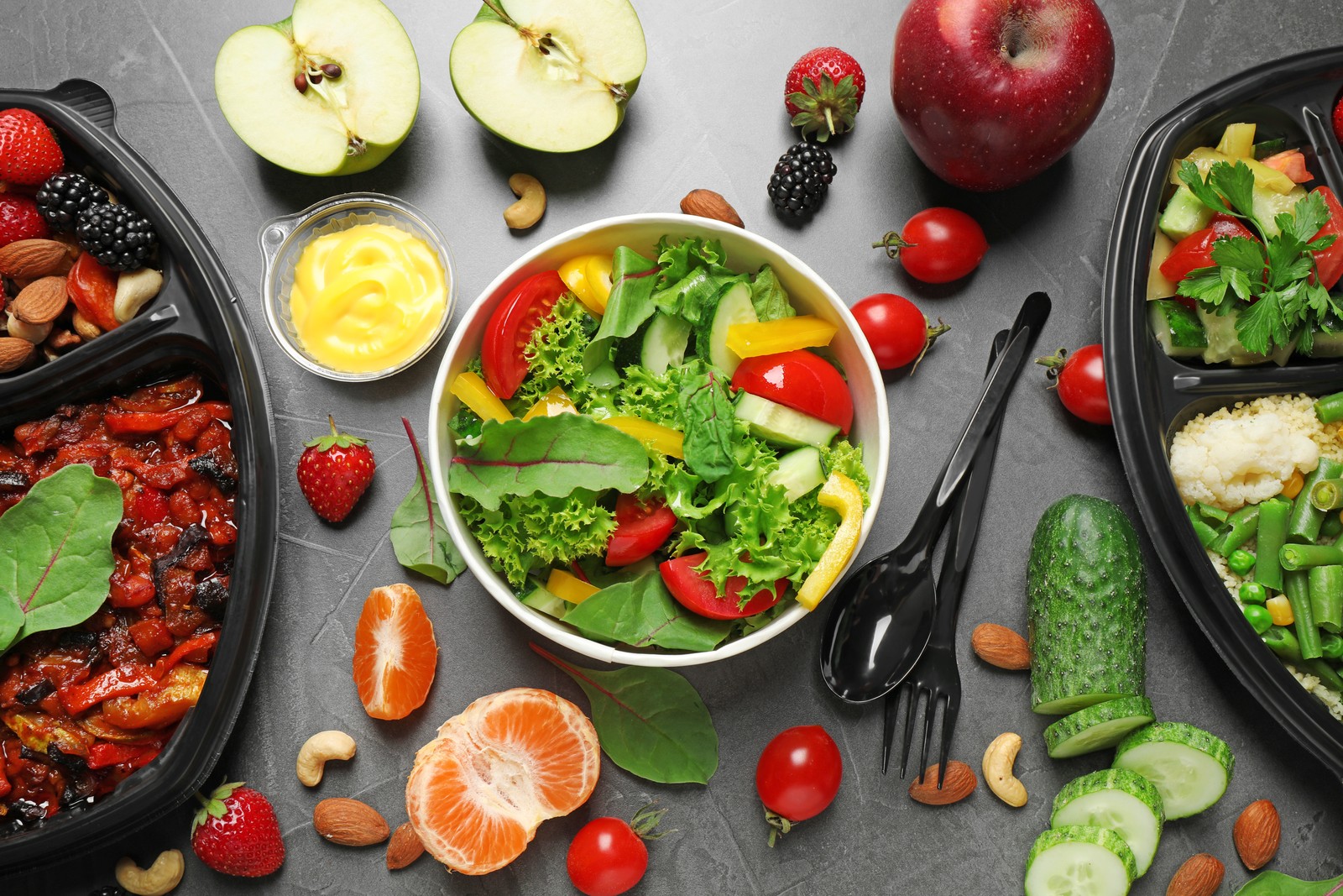 Photo of flat lay composition with lunchboxes on grey table. Healthy food delivery