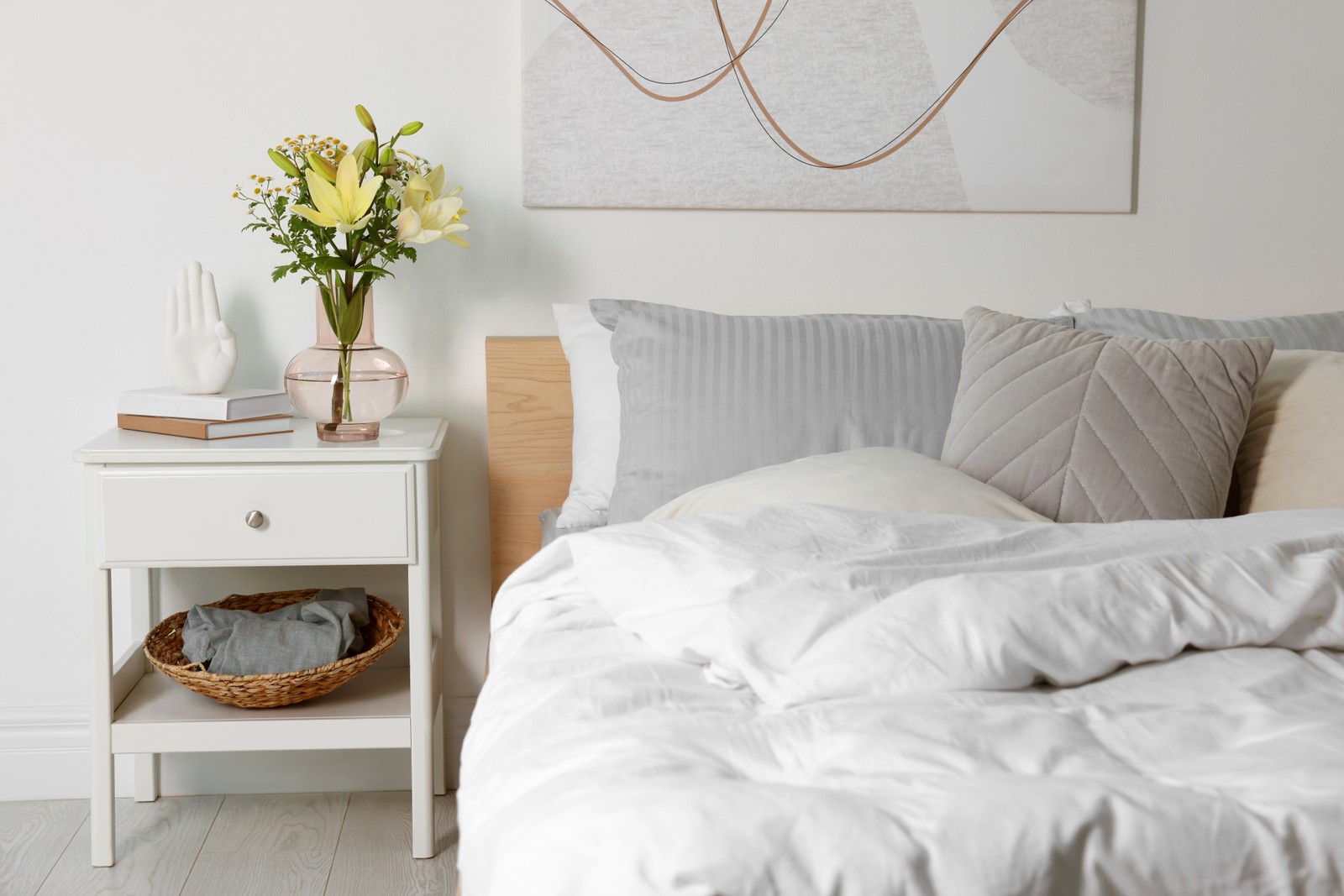 Photo of beautiful bedroom interior with fresh flowers and decor