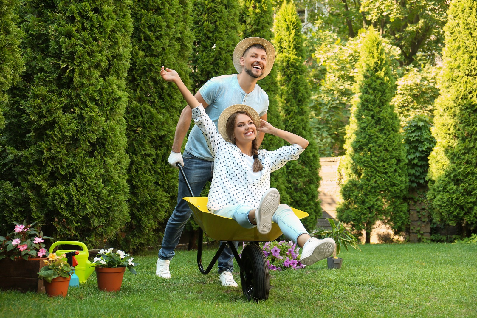 Photo of happy couple having fun while working together in garden