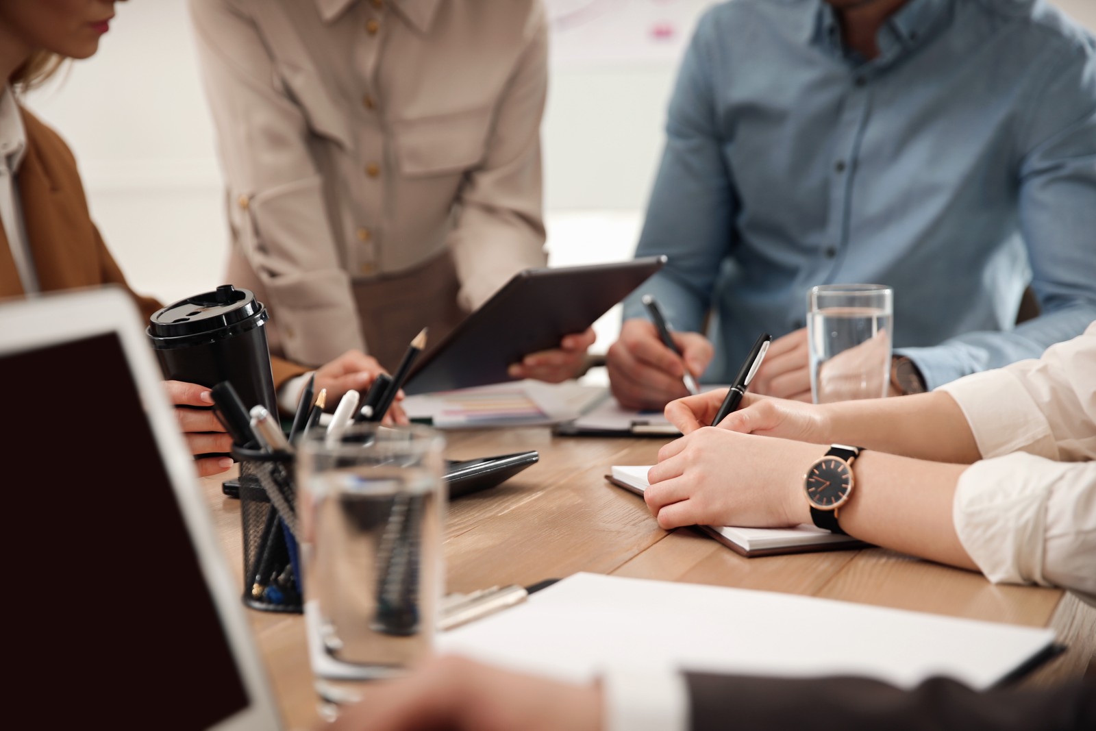 Photo of business people having meeting in office, closeup. Management consulting