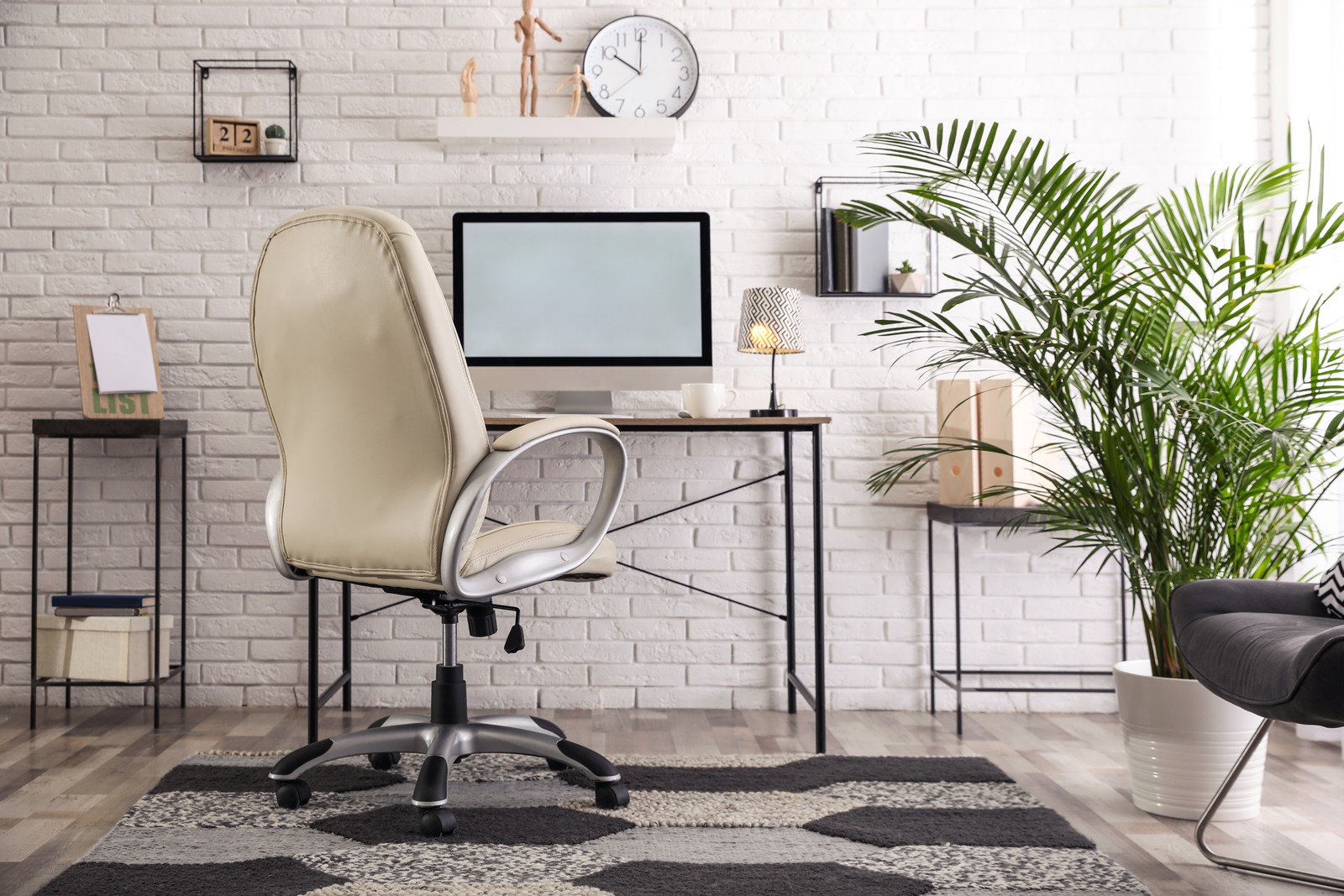 Photo of comfortable chair near desk in modern office interior