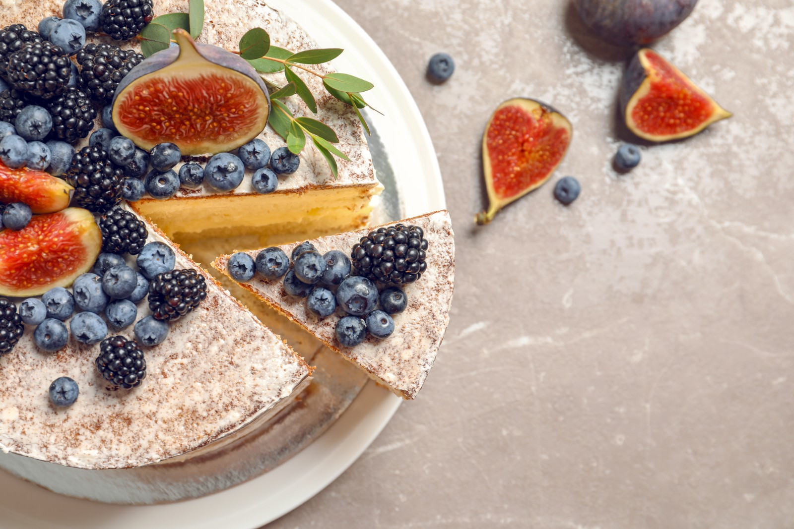 Photo of delicious homemade cake with fresh berries and space for text on table, top view