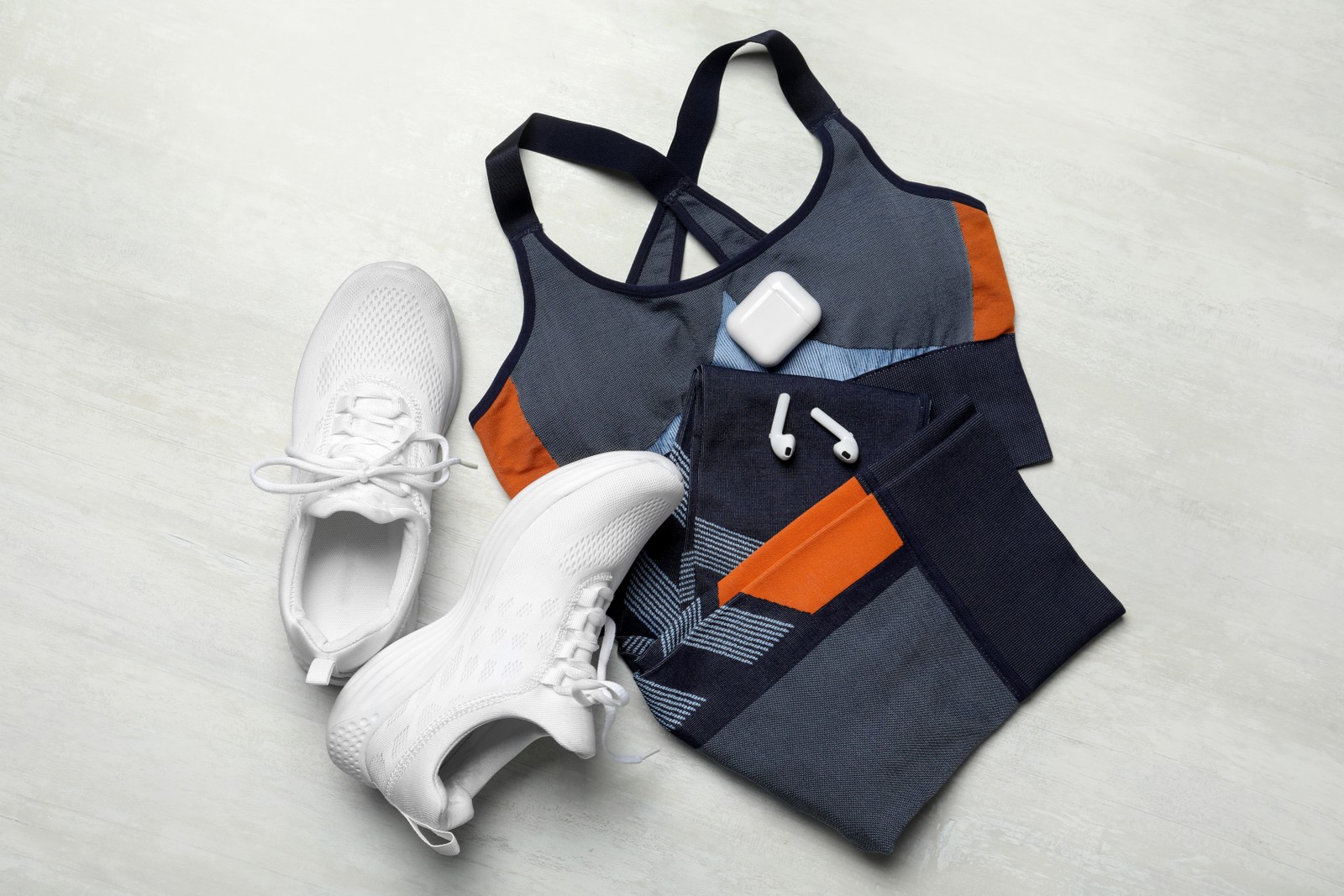 Photo of flat lay composition with stylish sport shoes on light background