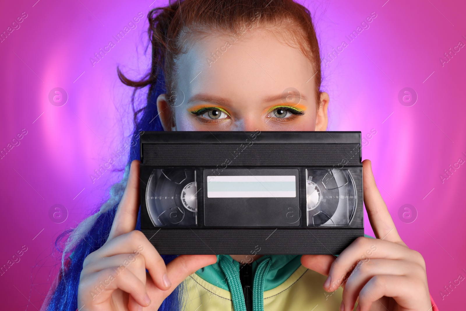 cute-indie-girl-with-vhs-cassette-on-violet-background-free-image