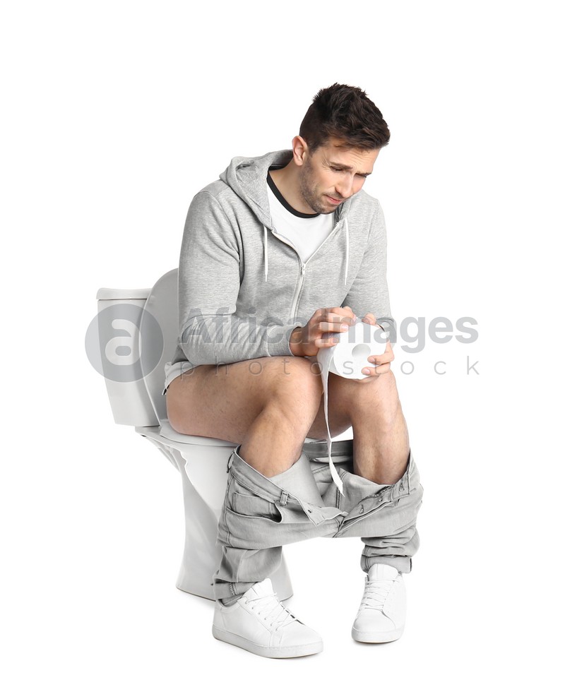 Man suffering from diarrhea on toilet bowl, white background: Stock ...